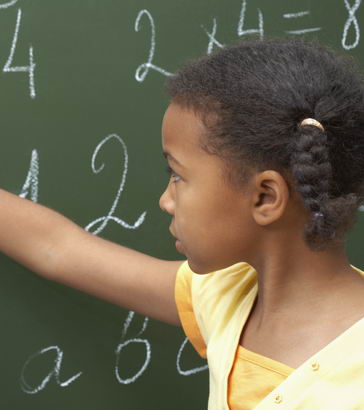 A typically developing young
girl uses a blackboard in class