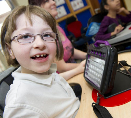 A girl laughing with her teacher