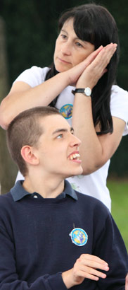 A happy confident boy with a parent and
carer