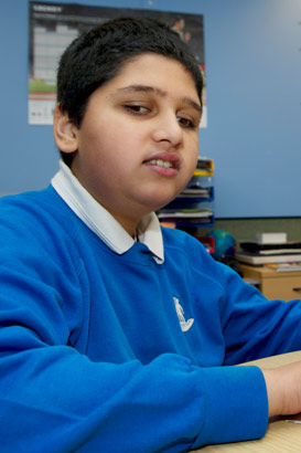 A boy with his teacher reading by
touch, using the Moon system