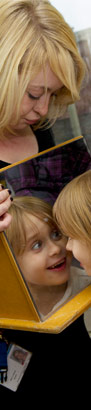 A girl looks at her reflection in
a mirror