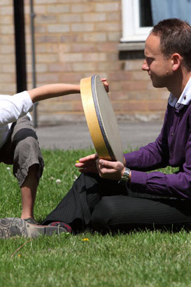 A boy and a man with a large drum