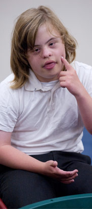 A seated girl gestures during an
oral skills class