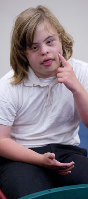 A seated girl gestures during an
                  oral skills class