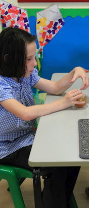 A teacher offers a girl a choice of two
objects