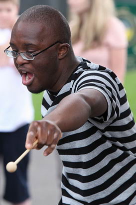 Black boy with drumstick at Riverside
                  school