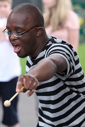 Black boy with drumstick at Riverside
school
