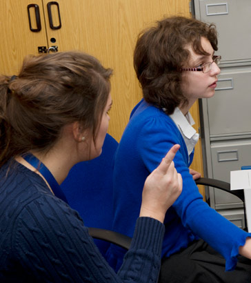 Two teenage girls take a written
test