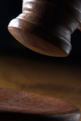 A brown gavel in use in a court of law