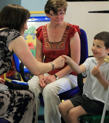 Seated boy with two adults