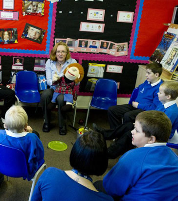 Children and adults participating in a
                  music activity