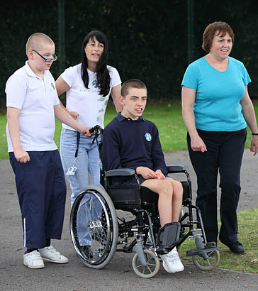 Carer holding distressed boy's hand