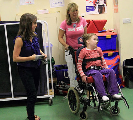 Two carers with child in wheelchair