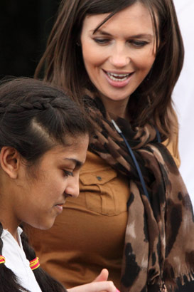 Girl holding carer's hand and walking