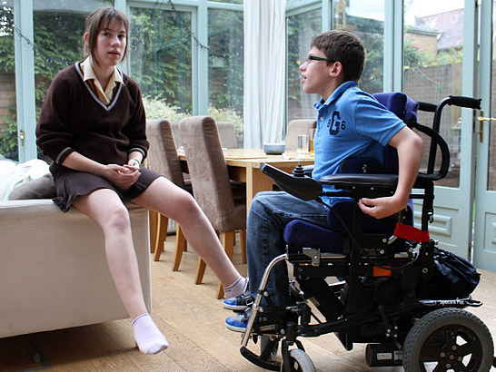 A boy in a wheelchair and his sister