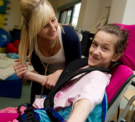 Girl in chair with carer