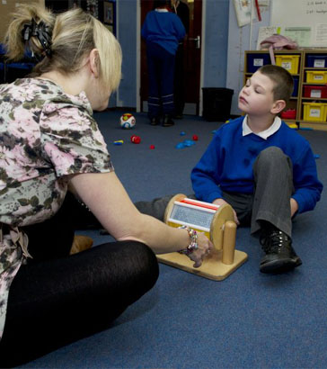 A boy and carer joining a group