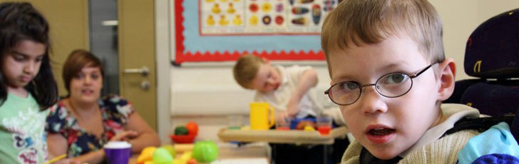 Boy and carer smiling at each other