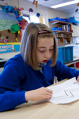 Girl drawing with teacher.