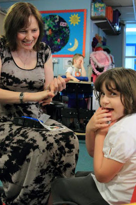 Woman signing with seated girl.