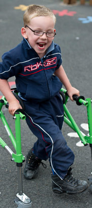 Laughing boy with walking aid