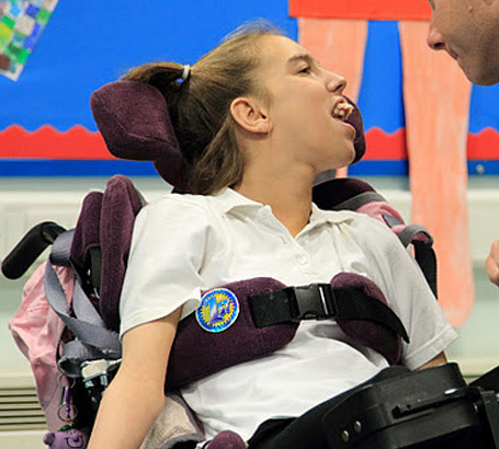 Girl in wheelchair interacting with carer