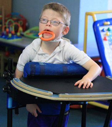 Boy chewing on ring