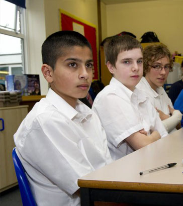 Boys of differing ethnicities listening