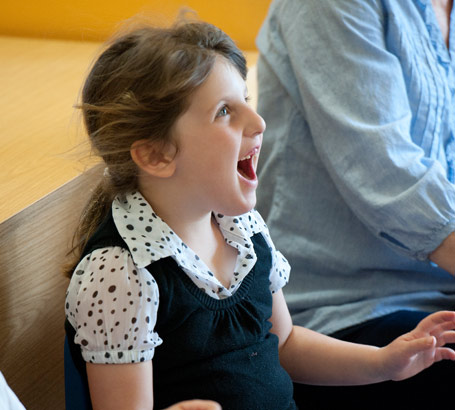 Young girl in polka dot blouse
                  and tank top has fun