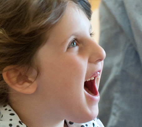 Young girl in polka dot blouse
                  and tank top has fun