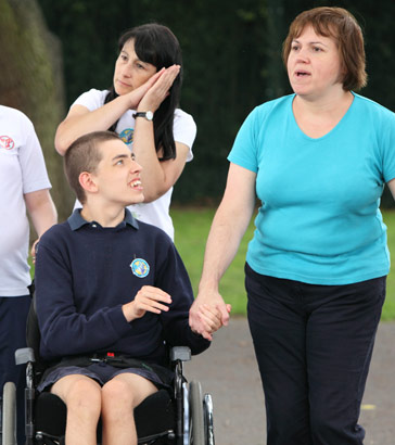 Adults and children holding hands outside,
                  forming close bonds to enable them to be proxy respondents