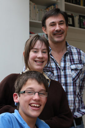 The whole family: sister and father stand
together with brother with complex needs
