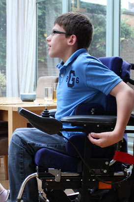 Brother in automated wheelchair talks to his
sister in the conservatory of their family home
