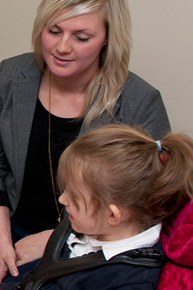 Family, staff and young girl discuss
                  opportunity structures around classroom table