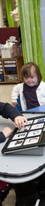 A teacher and teenage pupil link arms whilst
                  seated