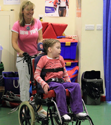 Carer with a child in a wheelchair