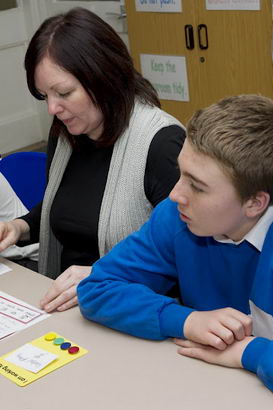 A teacher and three children in
                  an English lesson