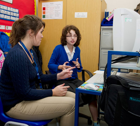 A girl and her teacher at a computer
during an English lesson