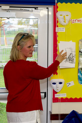 A girl and her teacher paint with
fingers