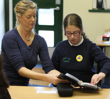 Teacher explains card to girl