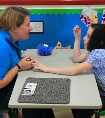 Teacher and girl interacting