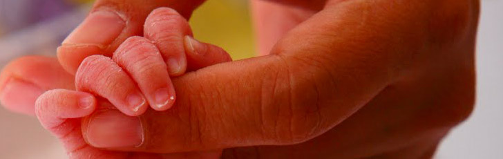Mother holding a baby's
hand