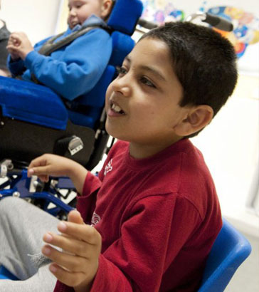 Teacher showing a small doll to a girl