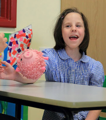 Girl playing with a pink rubber big