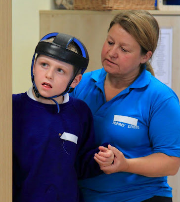 Teacher helping a boy