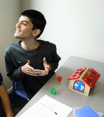 boy using a red scarf as part of
                  group activity