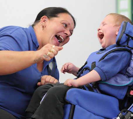 A teacher and a young boy use verbal and
non verbal cues to communicate