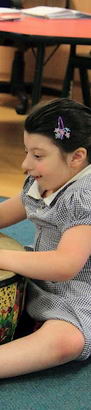 A female teacher and a young girl imitate
each other and touch hands