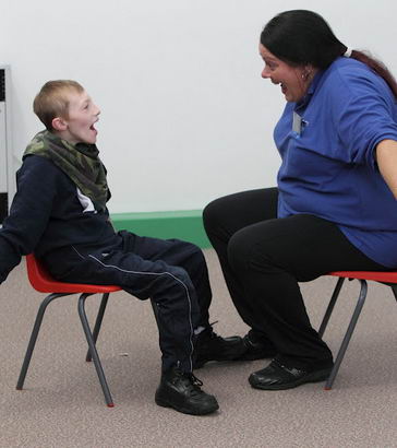 A female teacher uses Intensive Interaction
techniques with a young boy
