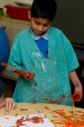 A young boy painting